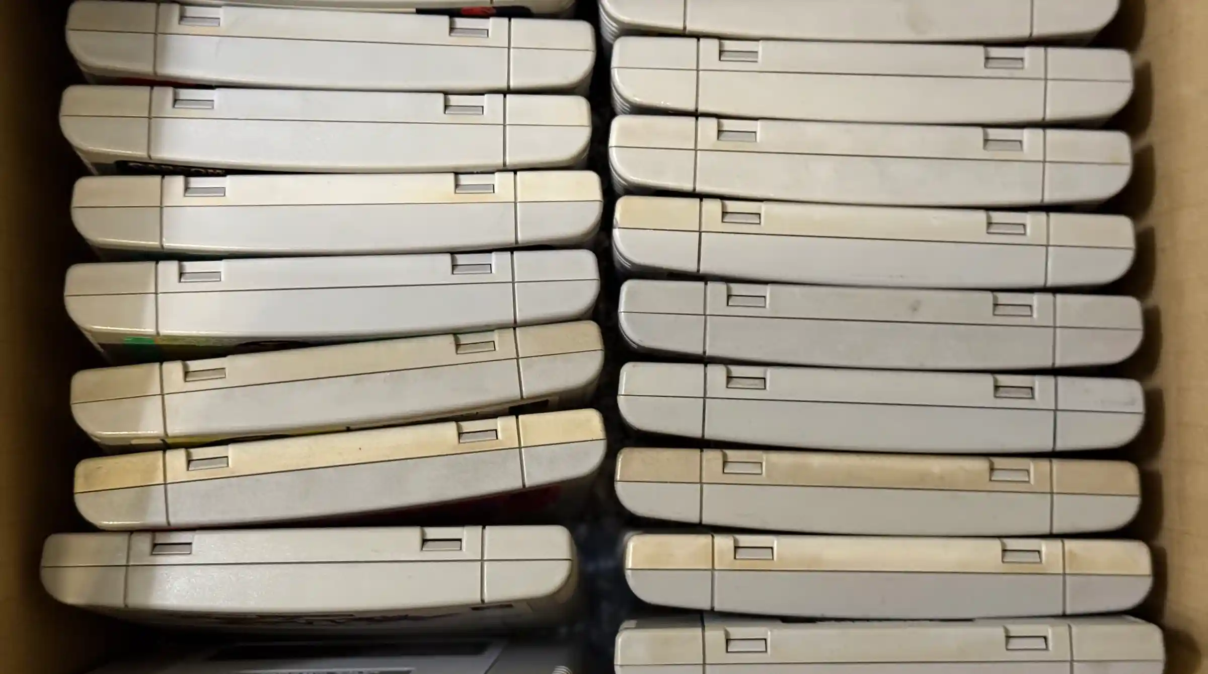 A box of vintage Super Nintendo consoles brought in to sell